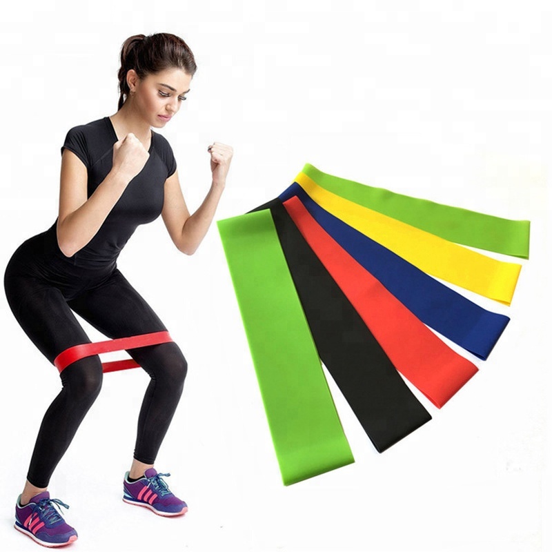 Woman Using Latex Exercise Resistance Bands