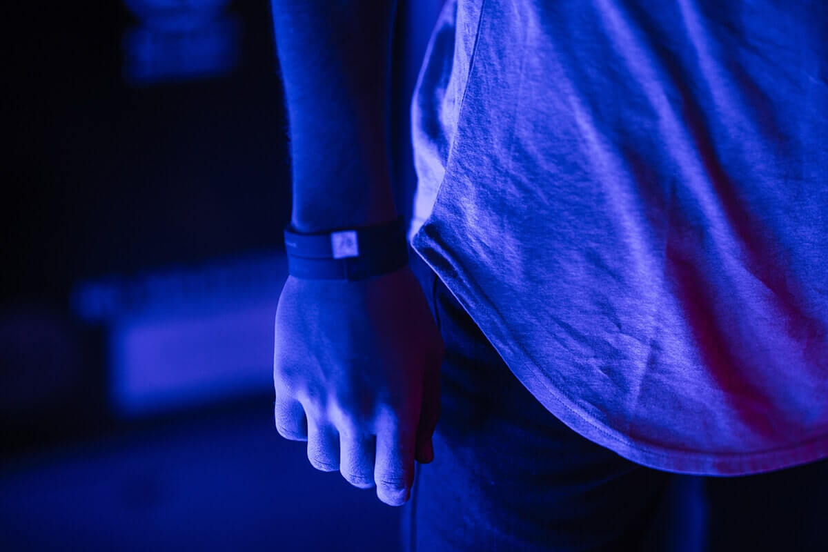 man in blue room wearing wristbands