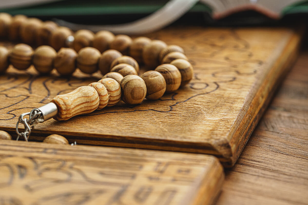 Oriental religious beads close up on a wooden table