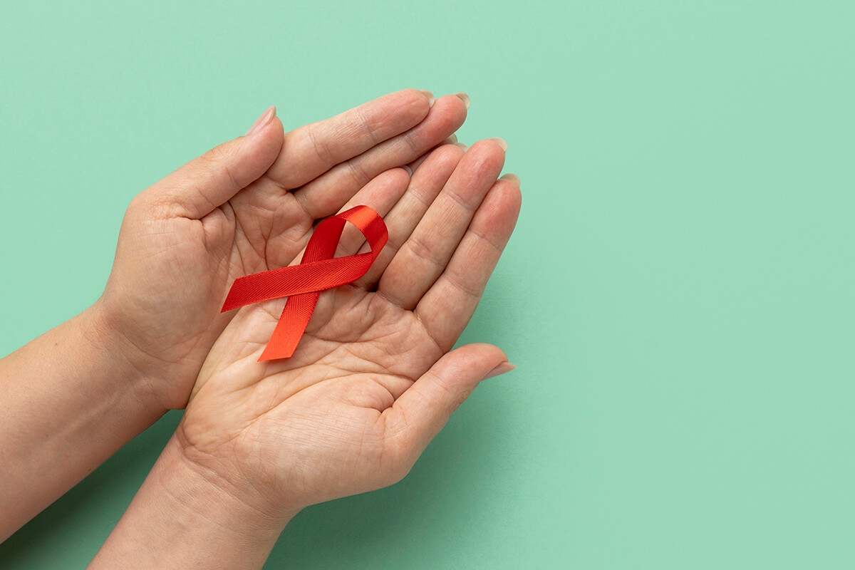 person-holding-world-aids-day-ribbon